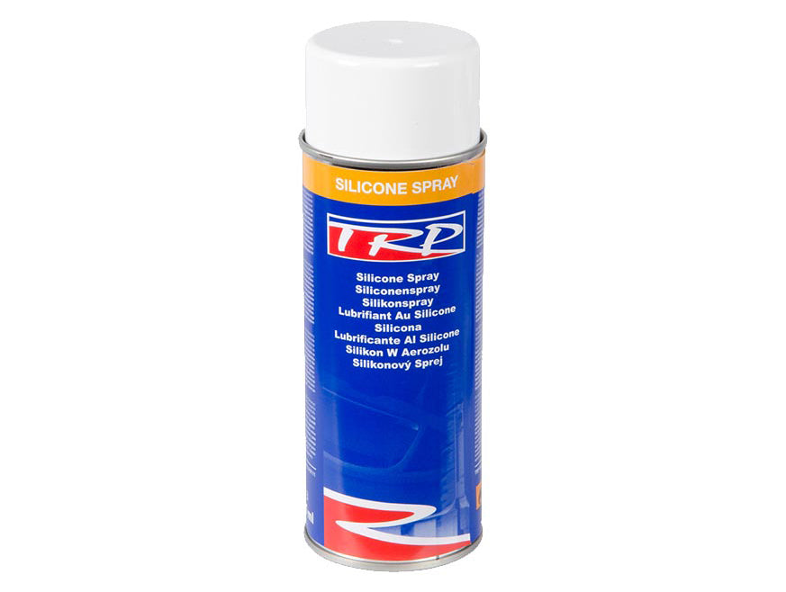 A can of TRP Silicone Spray featuring a white cap and blue, orange, and red label. The front displays the product name in several languages, emphasizing its role in lubricating and protecting plastic and rubber surfaces.
