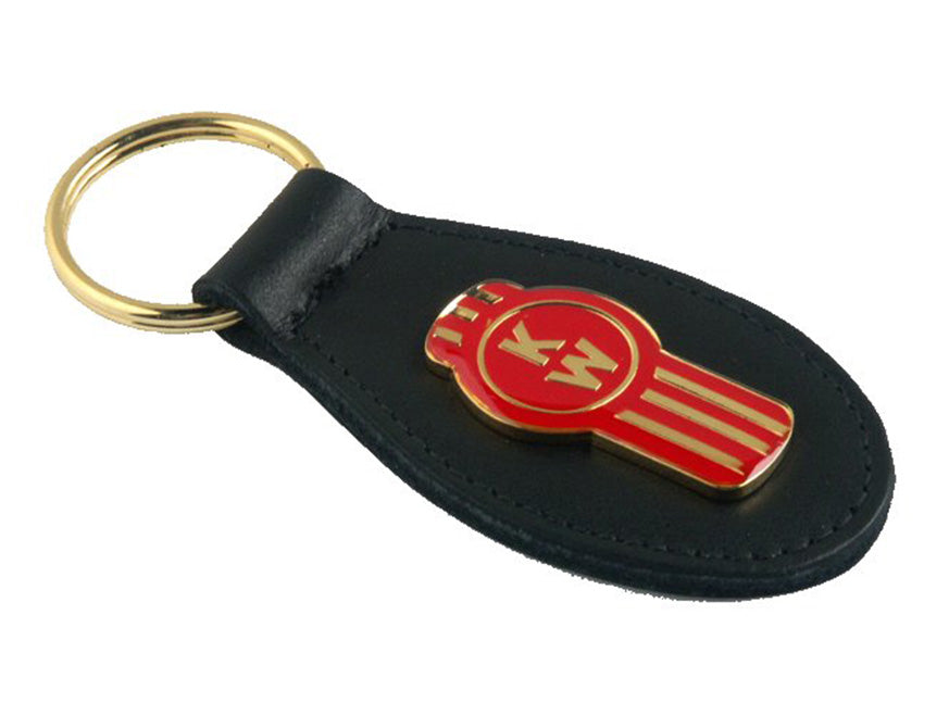 The KEYRING KENWORTH LEATHER features black leather, a gold key ring, and a red and gold emblem with stylized MM lettering—a must-have collectible for Kenworth fans.
