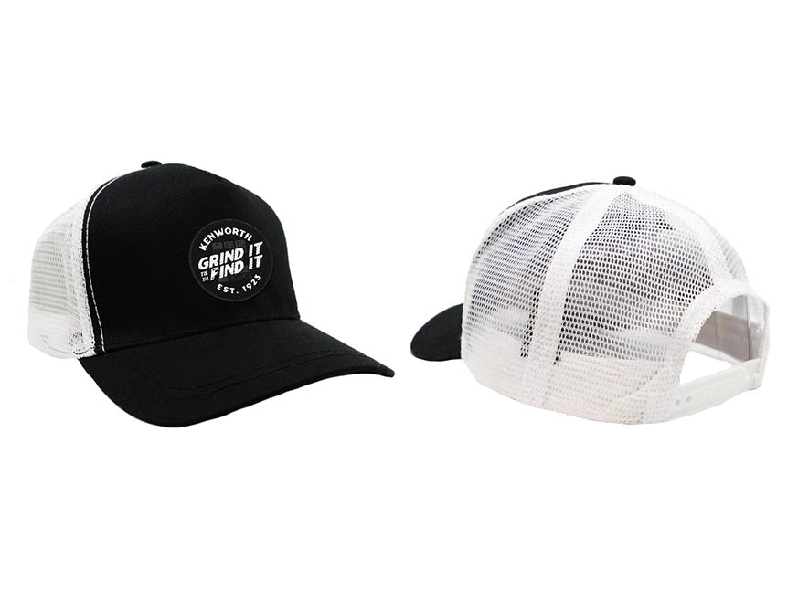 Two views of the CAP KW GRIND IT BLK/WHITE 2.0 with a breathable mesh back. The front displays a round Kenworth Grind It Find It Est. 1923 patch; one hat shows the front, the other features its adjustable trucker mesh back.