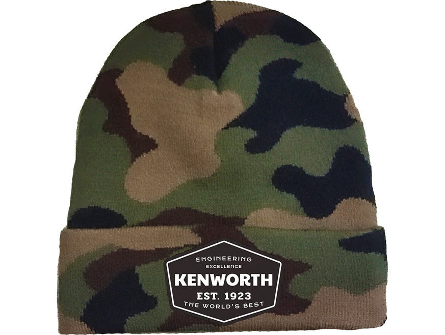 The BEANIE KW EXCELLENCE CAMO features a camo design and a black-and-white patch on the front cuff reading "KENWORTH EST. 1923 ENGINEERING EXCELLENCE THE WORLD’S BEST," perfect for celebrating Kenworth Engineering Excellence outdoors.