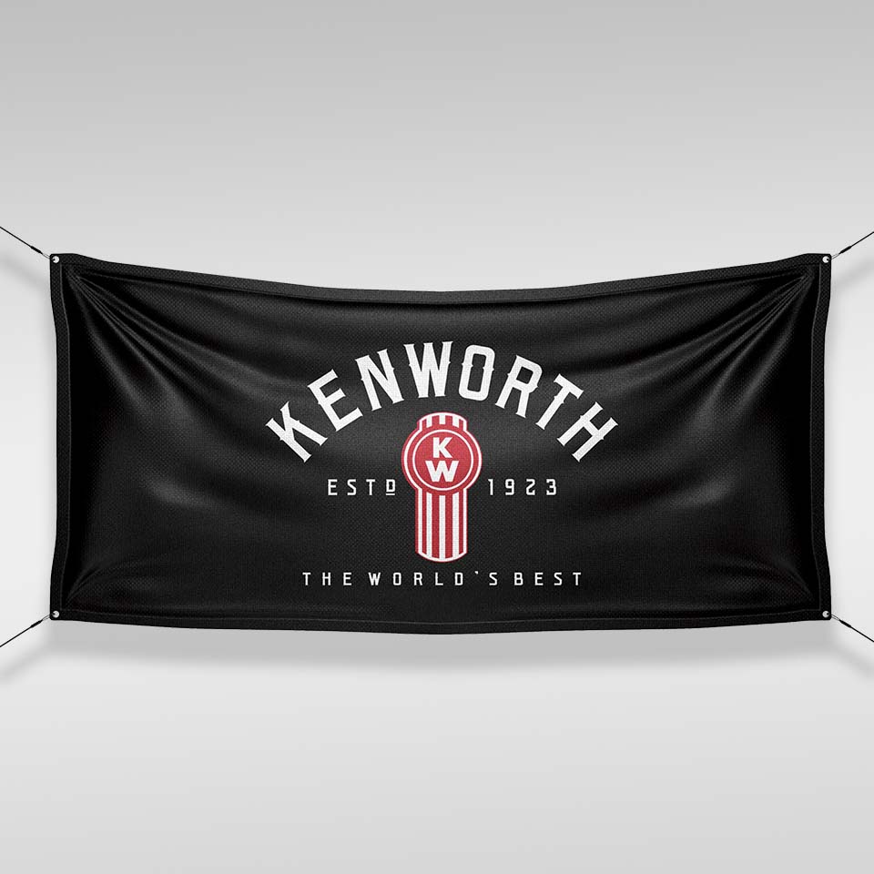 The FLAG KW CAB BLACK features the Kenworth logo in red and white with bold “KENWORTH”, “ESTD 1923”, and “THE WORLD'S BEST” text. This durable cab flag is ideal for truck garage decor and attaches at all four corners.