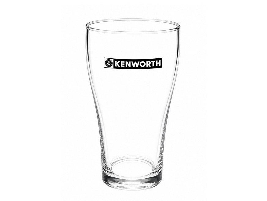 The GLASS KW BEER SCHOONER by Kenworth is a clear pint glass featuring the Kenworth logo in black and white on the upper front. Set against a plain white background, its laser etching stands out with precision.