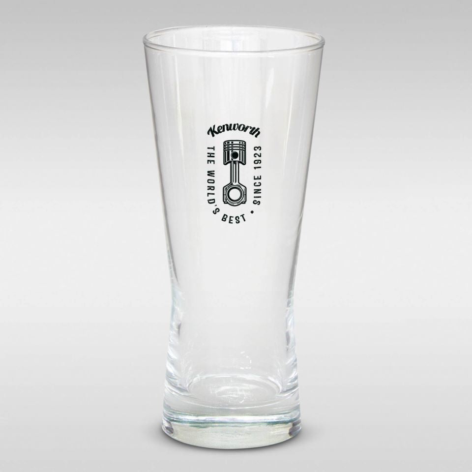 A clear GLASS KW BEER SCHOONER, 400ml, with "Kenworth, The World's Best, Since 1923" and logo printed in black on the front. It features a laser-etched base and is shown against a plain gray background.