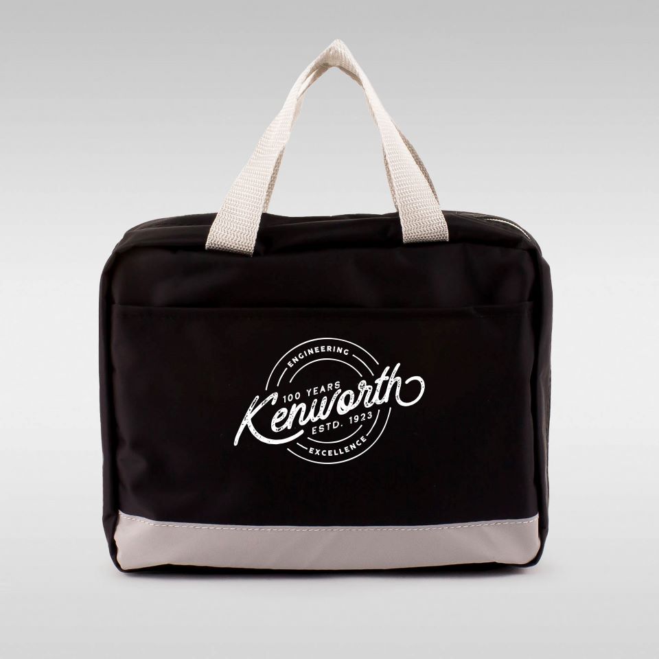 The FIRST AID KIT KW DELUXE is a black and gray rectangular tote with beige handles and a white "Kenilworth Engineering 100 Years Excellence Est. 1923" logo—ideal for carrying OSH-compliant first aid or essential medical supplies. Set against a light gray background.