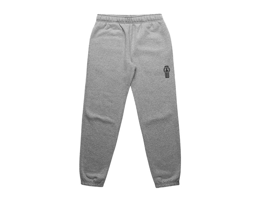 The SWEATPANT KW WOMENS GREY features an elastic waistband and cuffs, plus a black and white embroidered cartoon character on the upper left thigh. These comfortable grey lounge pants are shown laid flat on a white background.