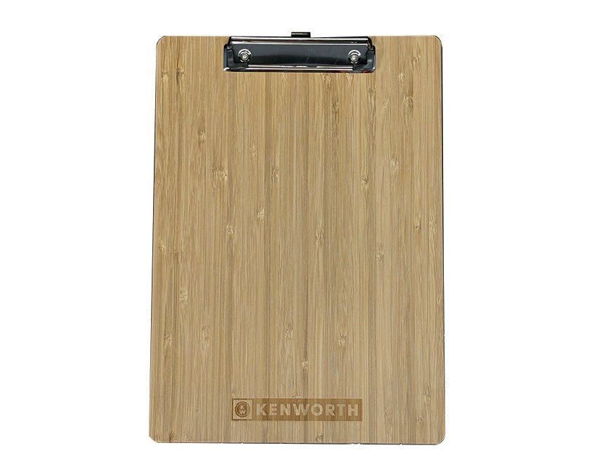 The CLIPBOARD KW is a bamboo clipboard featuring a metal clip at the top. "KENWORTH" is engraved near the bottom center, showcasing genuine Kenworth branding.