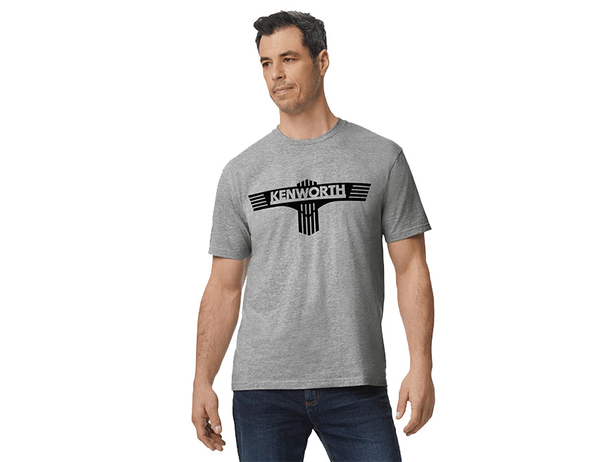 A man in a gray TEE SHIRT KW T BAR featuring a bold black truck-inspired chest design stands turned slightly to the side with a neutral expression.