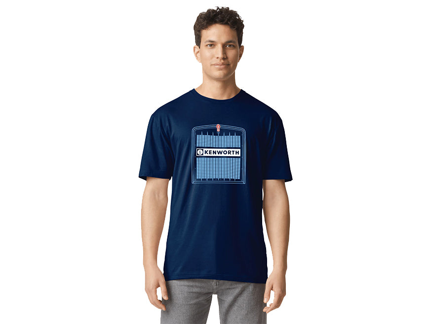 A man wears the TEE SHIRT KW GRILLE, a navy blue Kenworth tee with a bold truck grille graphic and central Kenworth logo, standing against a plain white background.