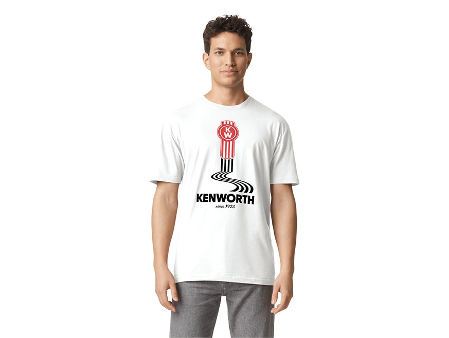 A person wears the TEE SHIRT KW LINES featuring a red Kenworth bug logo, a black winding road tyre mark design, and "KENWORTH since 1923" text on the front, set against a plain white background.