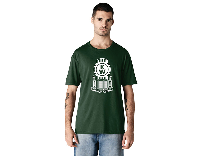 A man wears a dark green TEE SHIRT KW BUG GRILLE with a white and gray KW graphic and architectural elements, standing against a plain white background.
