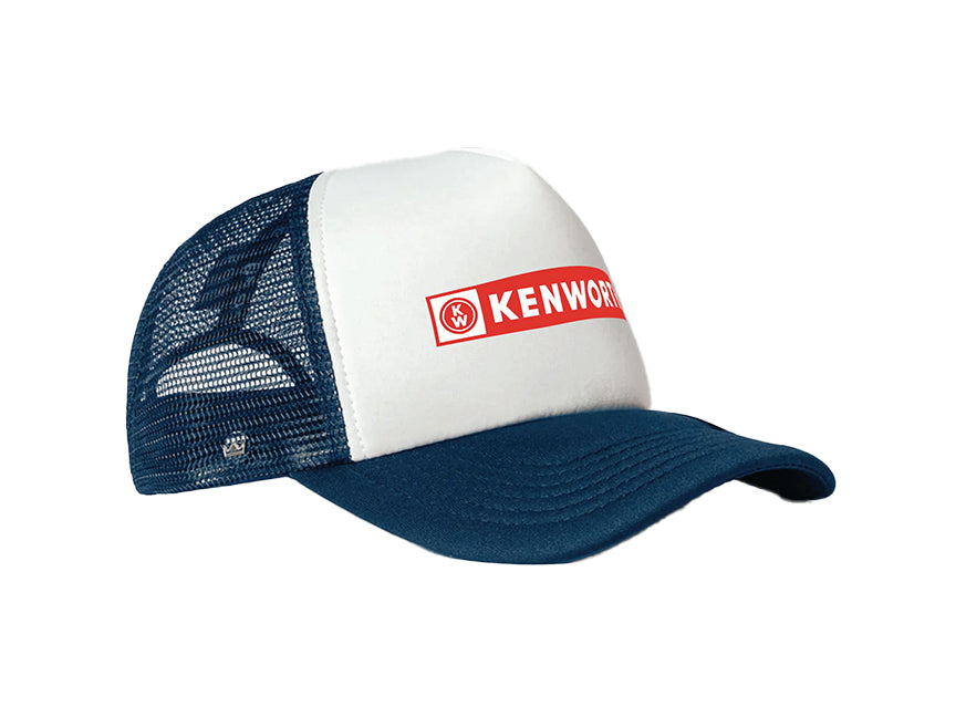 The CAP KW TRUCKER BLUE/WHITE features a white front, dark blue bill, mesh back, and displays a red rectangle with white KENWORTH text and circular logo on the front.