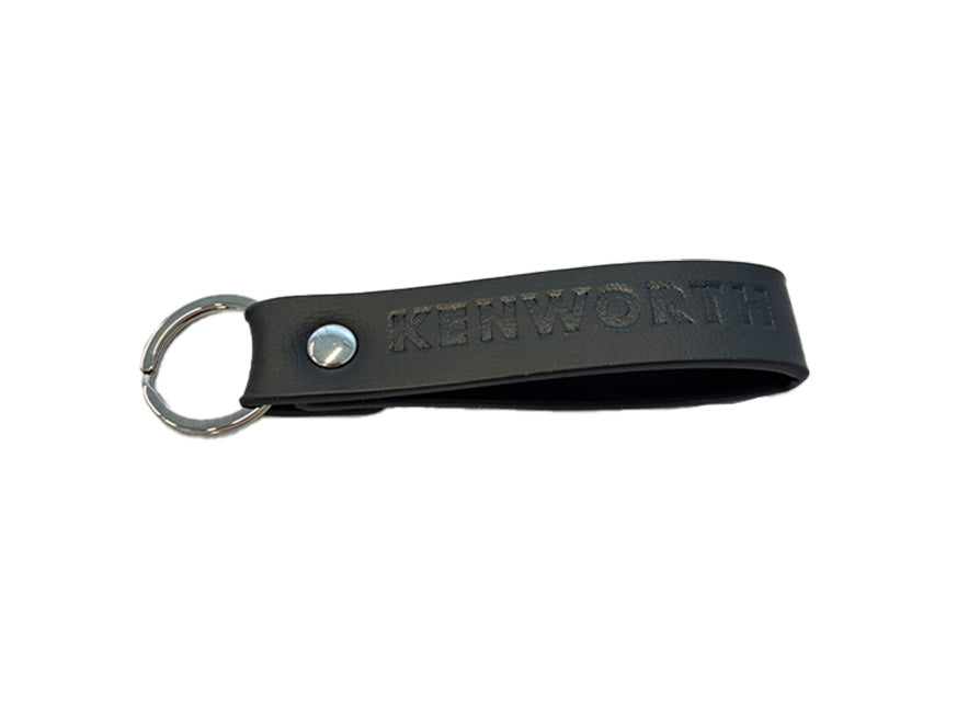 The KEYRING KW BLACK LOOP is a black leather keychain with a metal ring and rivet, embossed with the Kenworth logo—a stylish accessory for any driver.