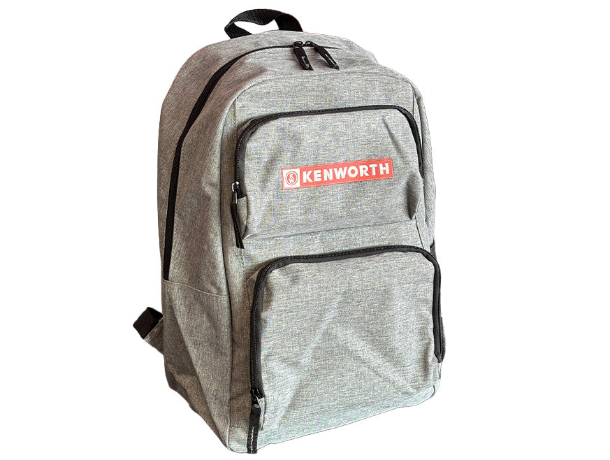 The BACKPACK KW GREY is a light gray, durable backpack with black zippers, a front pocket, and a red and white KENWORTH logo—ideal for daily use at work or school.