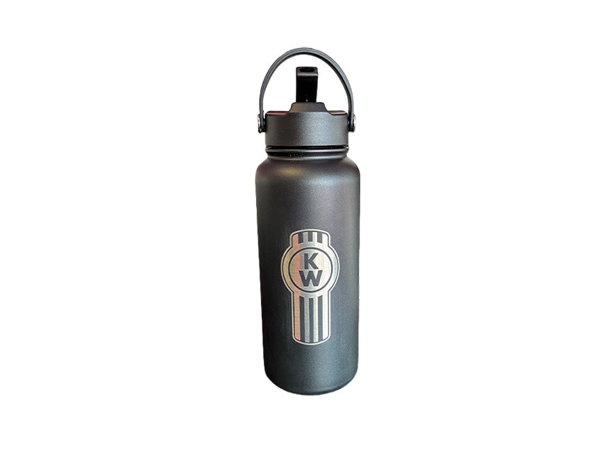 The BOTTLE KW VACUUM S/S is a black stainless steel bottle with a metal handle and a vertical Kenworth logo—K and W inside a circular emblem—on the front. Ideal for hydration, it stands out against any white background.