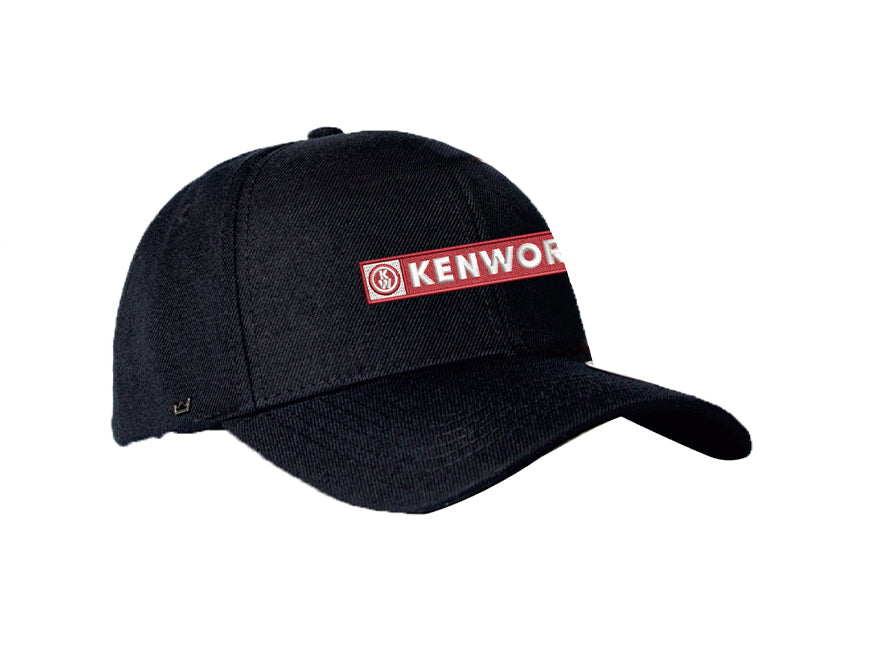 The CAP KW BANNER KIDS BLACK is a black kids’ snapback cap featuring a red and white KENWORTH logo, curved brim, visible stitching, and adjustable fit for comfort.