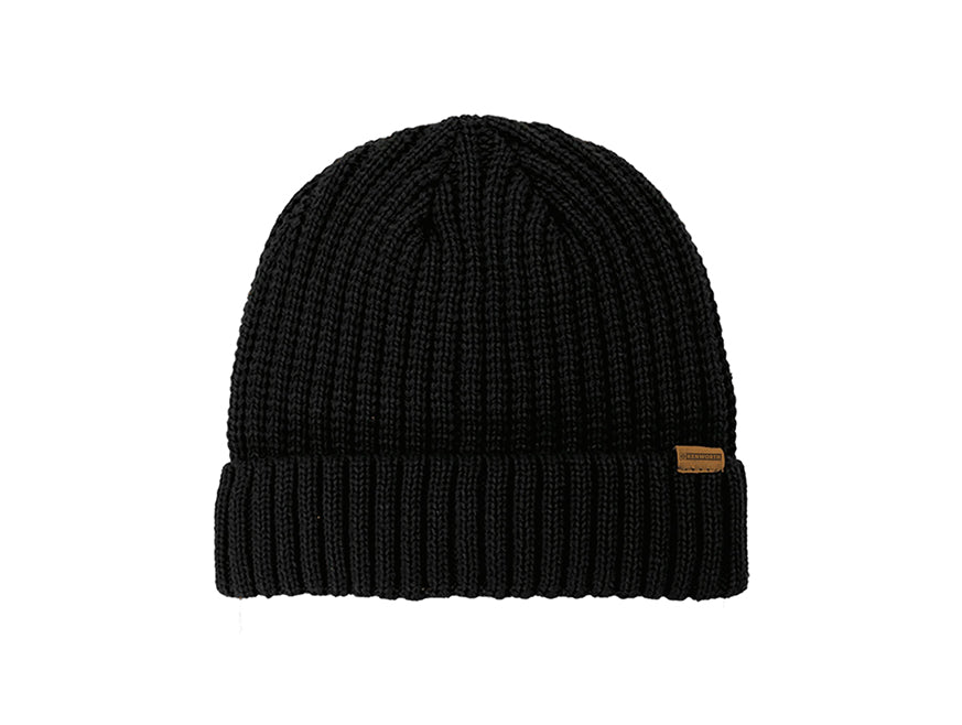 The BEANIE KW PREMIUM BLACK is a black ribbed knit beanie with a folded cuff and small brown rectangular tag, designed for a snug fit and shown on a white background.