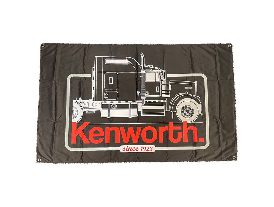 The FLAG KW CAB BLACK T909 displays a white line drawing of a Kenworth semi-truck on black, with "Kenworth" in bold red letters and "since 1923" below, embodying the iconic spirit of the open road.