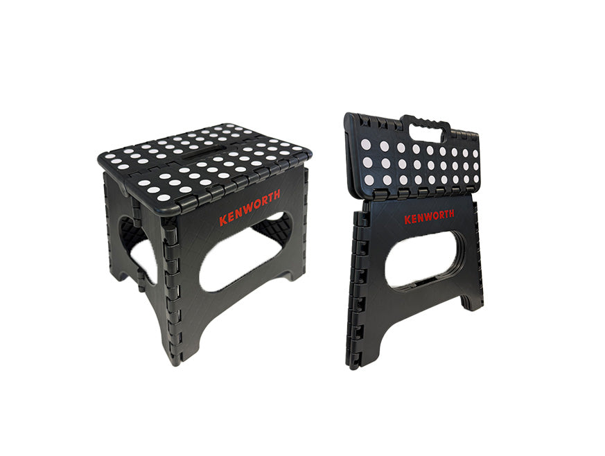 Two Kenworth Foldable Stools in black with white polka dots on top and "KENWORTH" in red on the sides. One heavy-duty stool is open, the other is folded for easy carrying; both feature a convenient foldable design.
