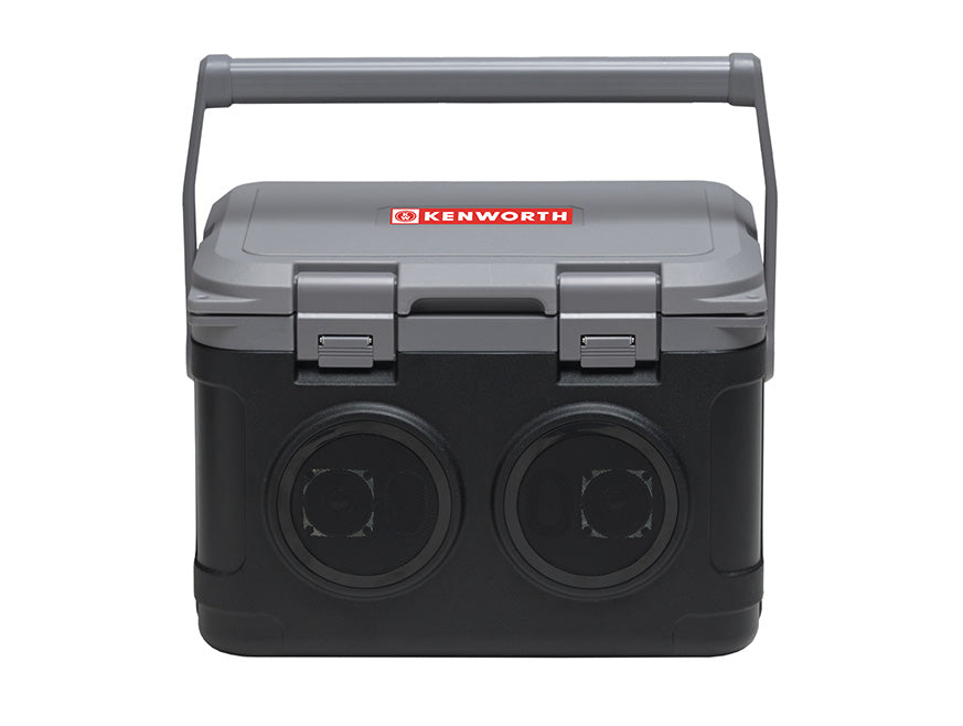 The Kenworth Cooler x Bluetooth Speaker is a black and gray cooler with a handle, the Kenworth logo on the lid, and two large front speakers—your 2-in-1 essential for worksites or outdoor events.