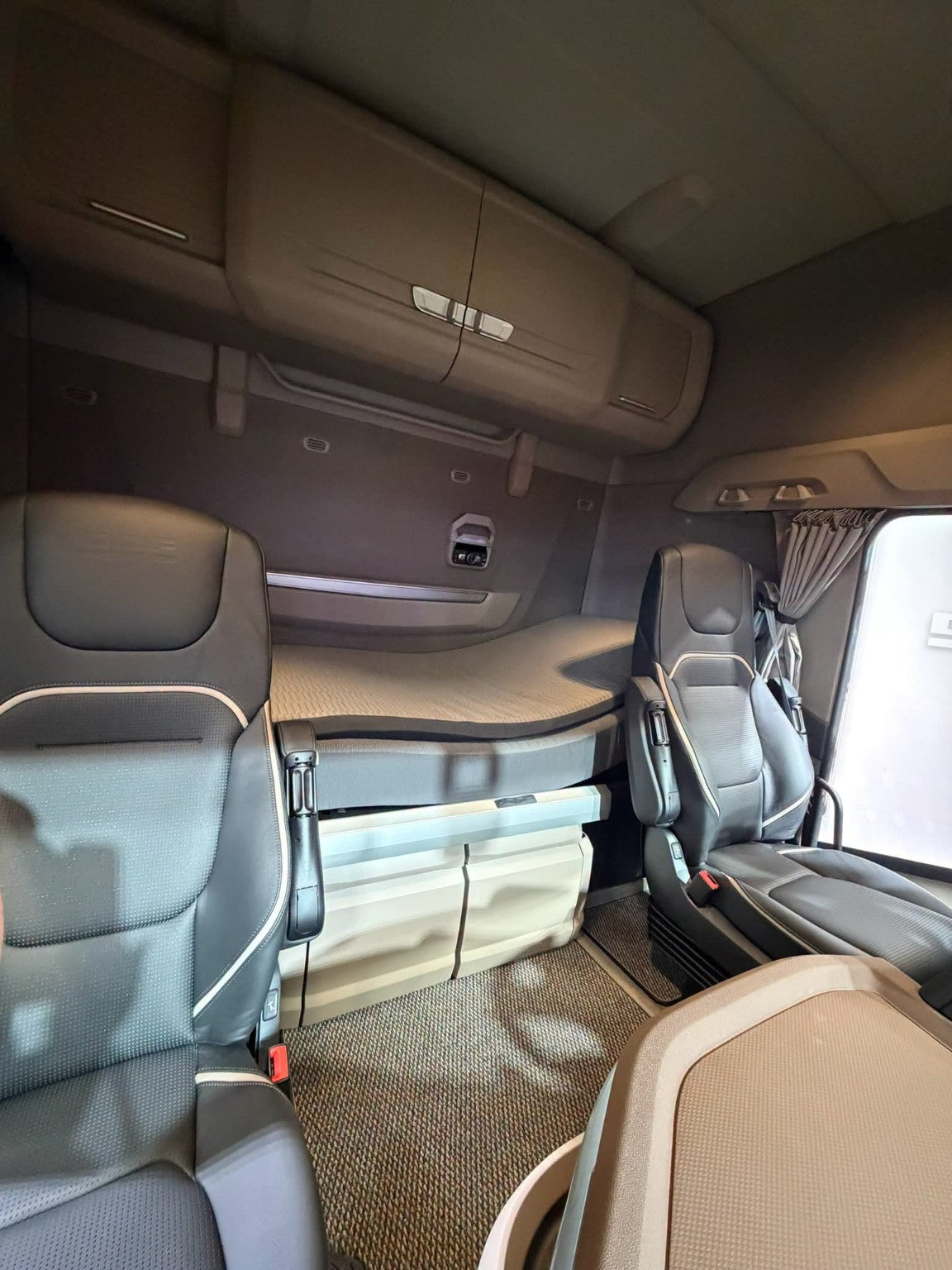 New Generation DAF cab interior showing the driver seat, dashboard and sleeper bunk