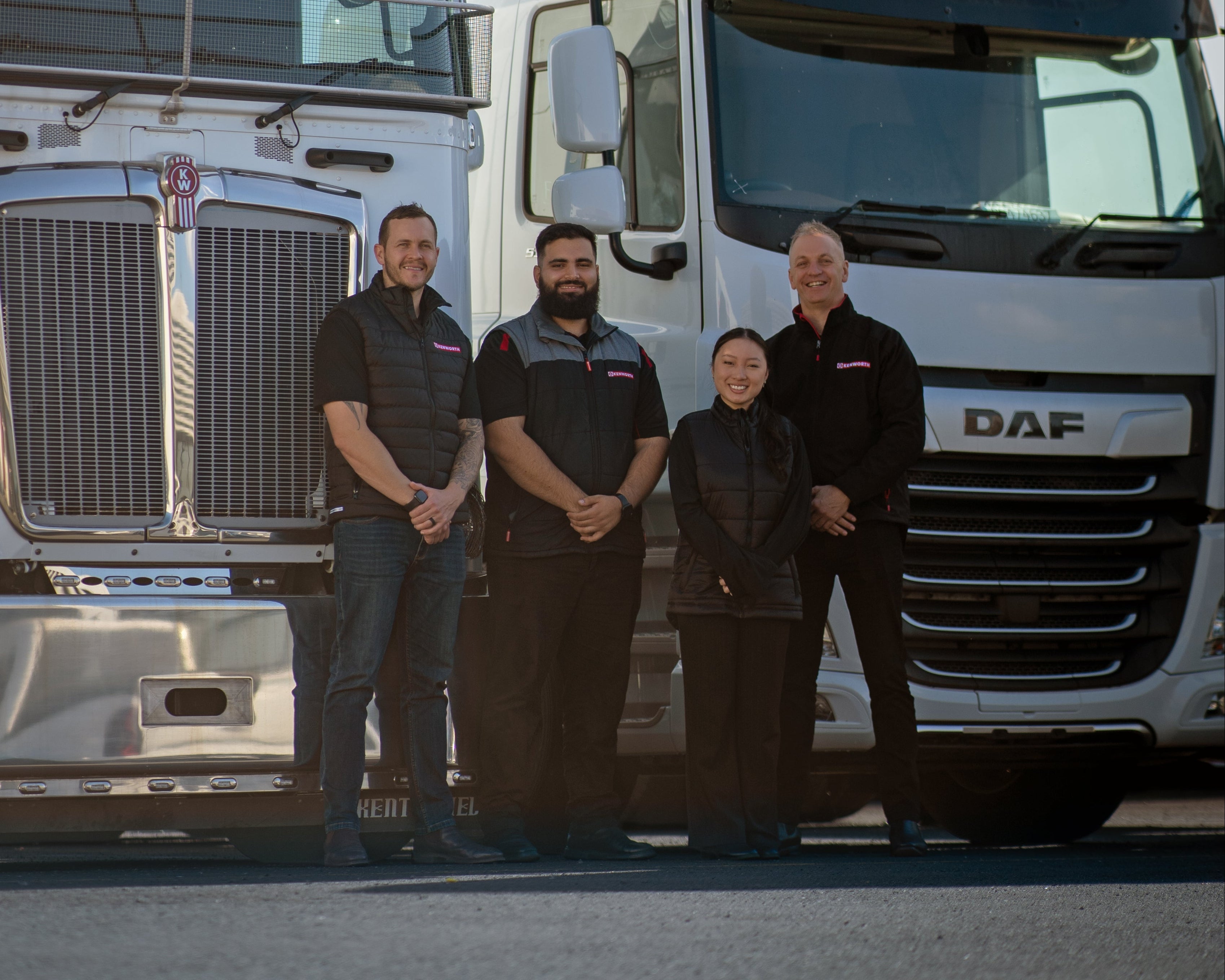 Team wearing truck brand work pants and shorts posing in front of a truck for work and weekends.
