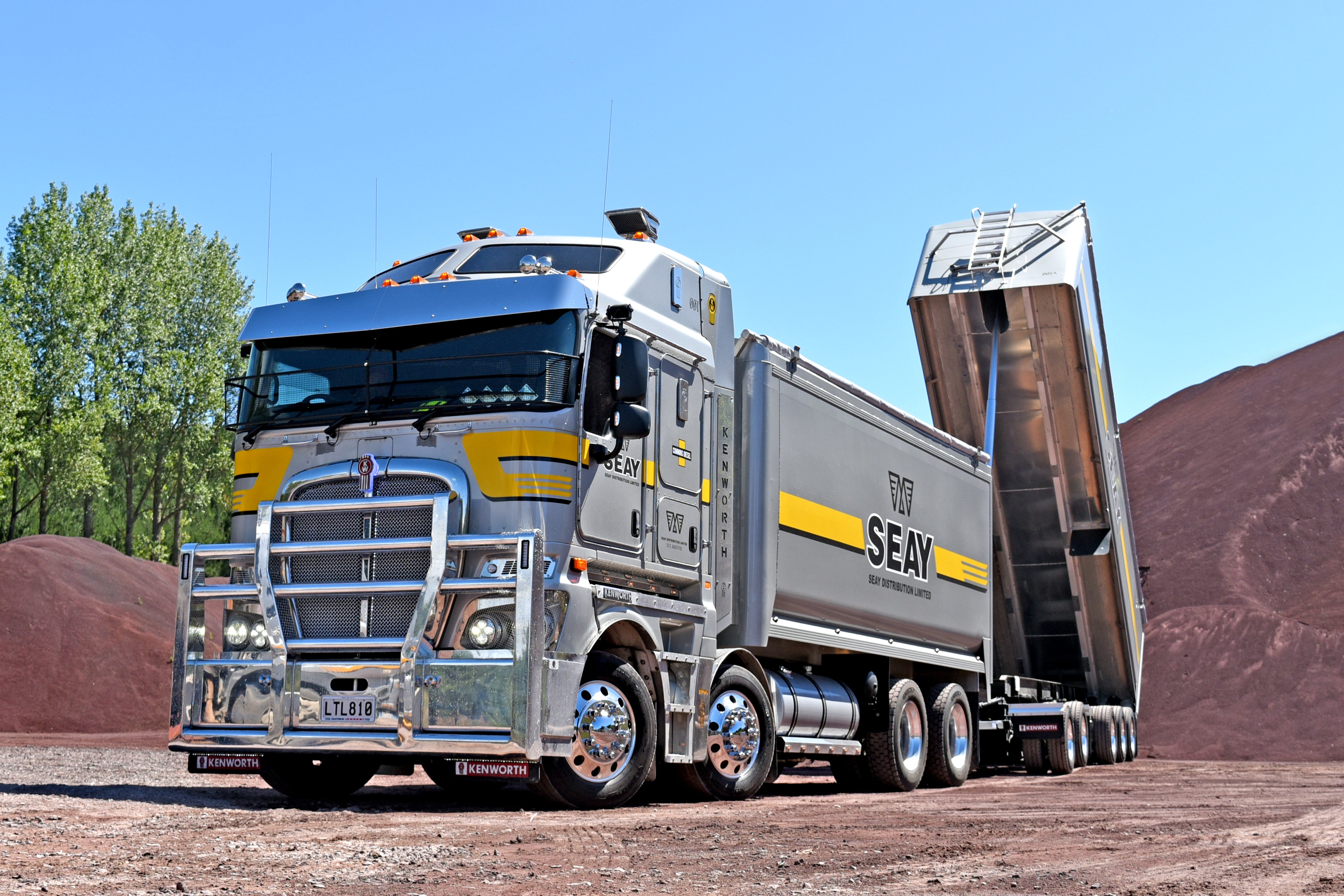 Genuine Kenworth truck parts showcased on a Kenworth truck with a vibrant background.