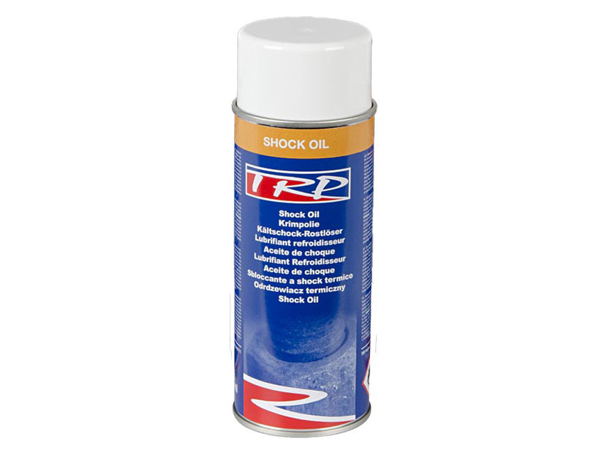 A blue spray can with a white cap labeled SHOCK OIL 400ML LOOSENING RUST. The multilingual label describes it as a shock oil lubricant with advanced thermal technology for loosening rust.