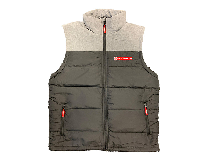 The VEST KW PUFFER GREY / BLACK is a sleeveless, quilted gray and black vest with a high collar, two front zippered pockets, and a red Kenworth logo patch on the upper left chest.