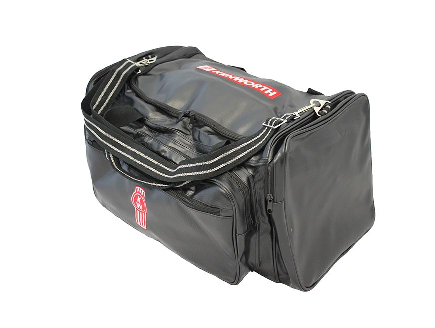 The BAG KW PREMIUM is a black 50L Kenworth travel bag with a shoulder strap, zippered compartments, and the Kenworth logo in red and white on the side and top—ideal as a weekend or travel bag.