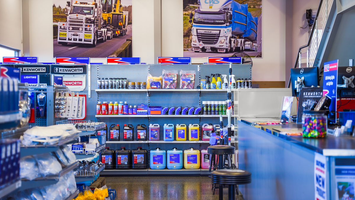 Southpac store interior with shelves stocked with various products and promotional posters of trucks on the wall.
