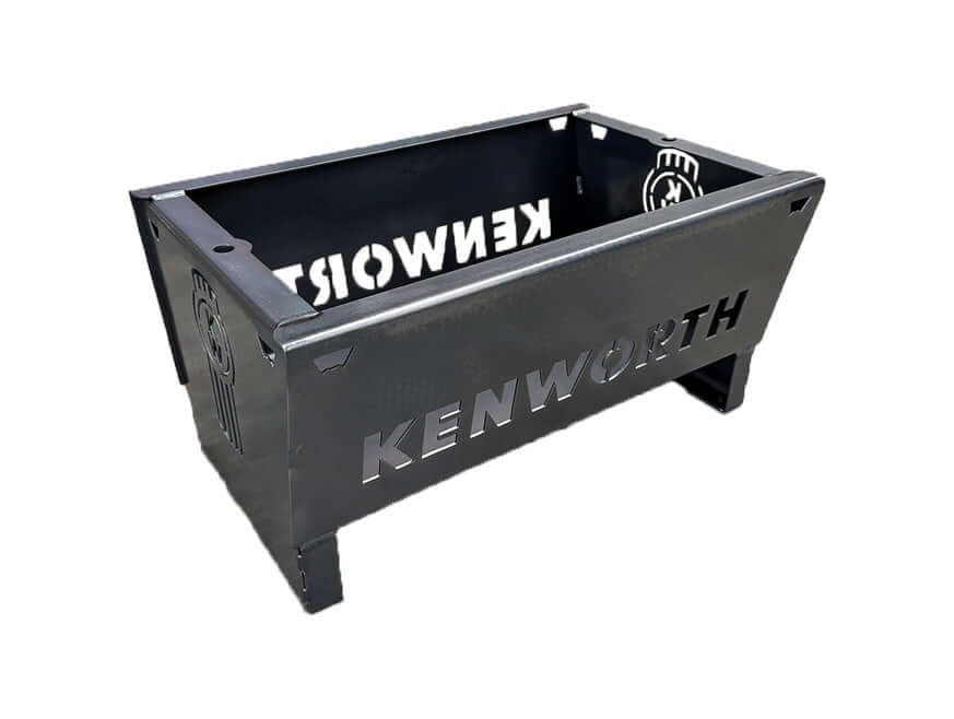 The FIREPIT KW STEEL is a heavy-duty rectangular steel firepit featuring "KENWORTH" cut out on the sides, short legs for elevation, and Kenworth logos on both end panels.