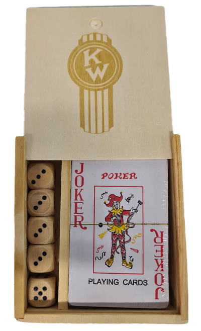 The GAME SET KW BOXED is a wooden gift box with a sliding lid labeled KW, containing four wooden dice and a deck of playing cards with the Joker card displayed on top.