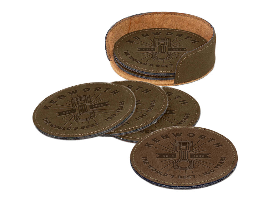 The COASTER KW BROWN is a set of round PU coasters embossed with "Kenworth The World's Best 100 Years," partly stacked in a matching brown leather holder.