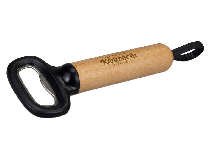 The BOTTLE OPENER KW WOOD & S/S features a wooden handle, black stainless-steel opener top, hanging loop, and "Kenworth" engraved on the side.