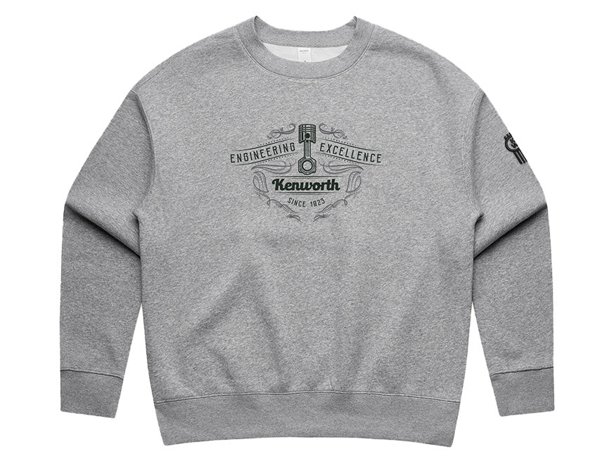 The SWEATSHIRT KW GREY WOMENS features a Kenworth logo and "Engineering Excellence Since 1923" in black on the chest, plus a small emblem on the upper sleeve for extra detail.
