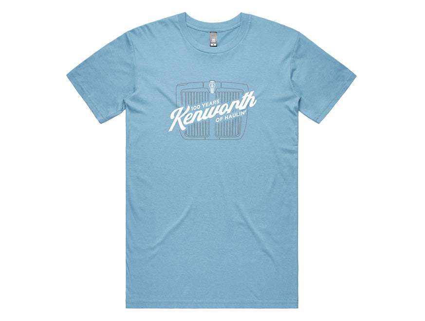The TEE SHIRT KW HAULIN BLUE features a light blue design with a white outlined truck grille and "100 Years Kenworth of Haulin’" heritage graphic printed on the chest.