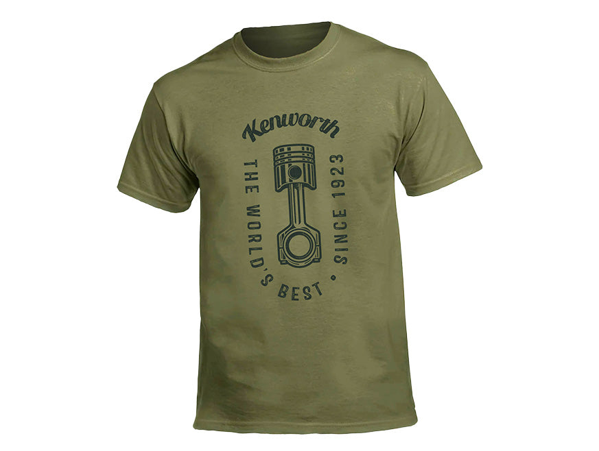 The TEE SHIRT KW WORLDS GREEN is an olive-green tee with a bold piston graphic and "Kenworth The Worlds Best Since 1923" printed in black—perfect for truck enthusiasts seeking a heritage look.