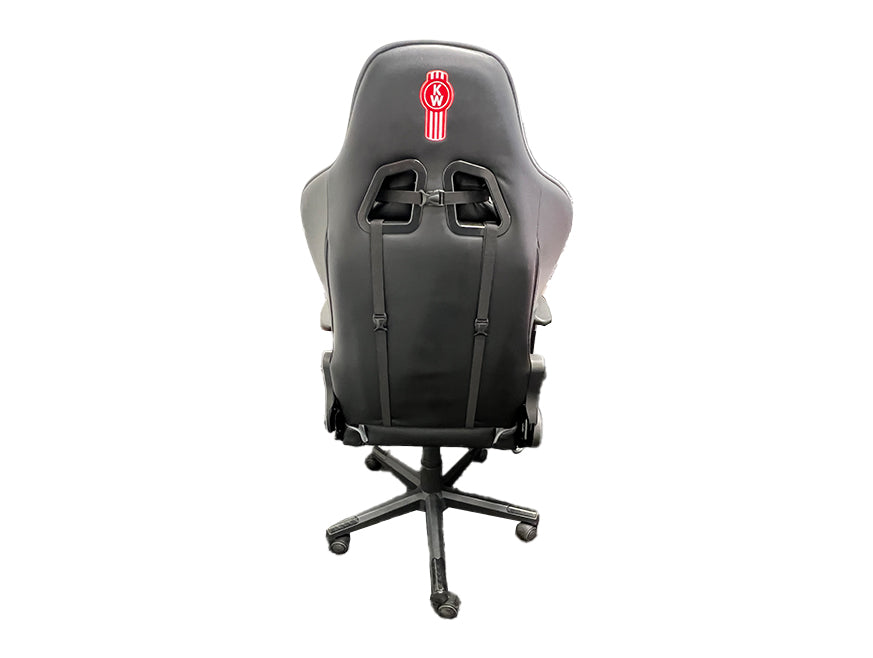 The CHAIR KW OFFICE BLACK is an ergonomic office chair in black, shown from the back with a red and white embroidered logo at the top, adjustable straps on the backrest, and a five-wheel base.