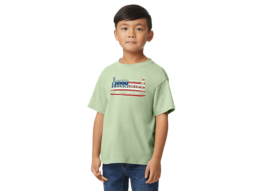 A young boy with short dark hair wears a TEE SHIRT KW KIDS FLAG, featuring a truck and American flag graphic, standing against a plain white background.