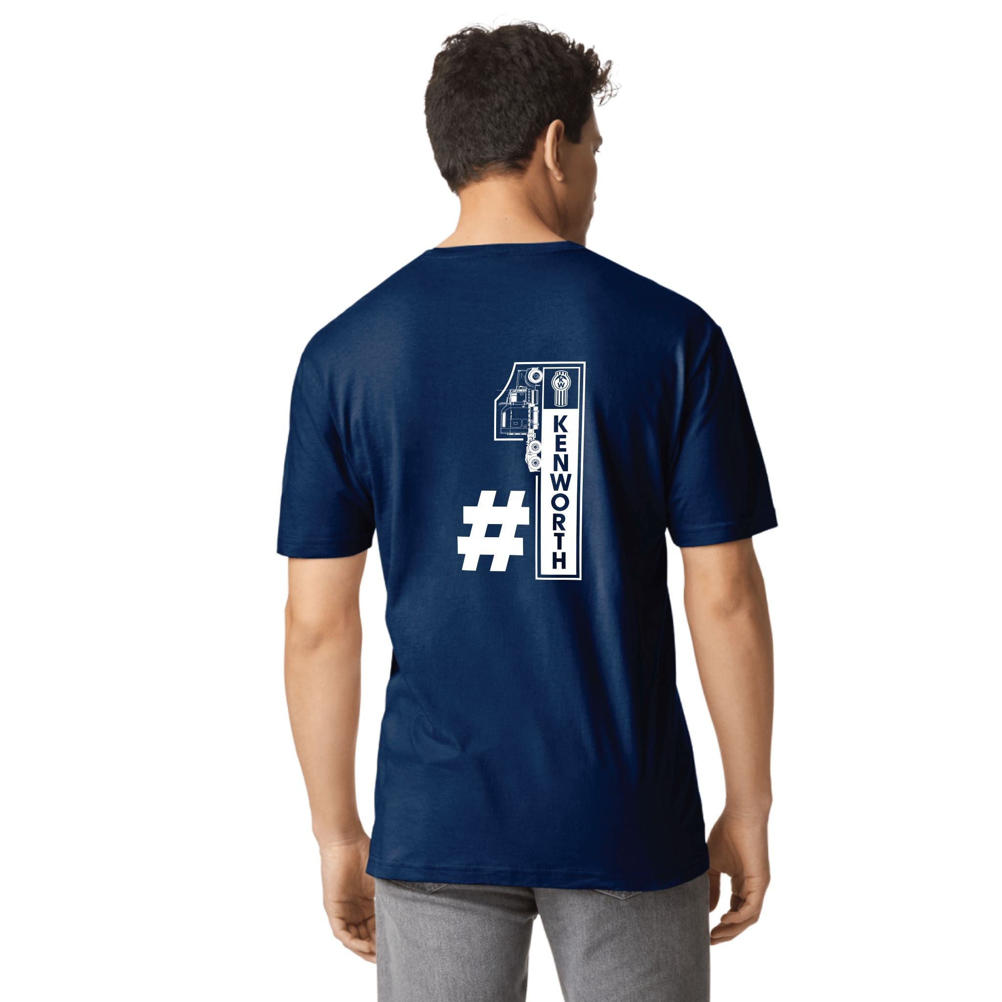A man wearing the TEE SHIRT KW NO1 NAVY—a classic navy blue Kenworth tee featuring a bold white number 1, a hashtag, and "KENWORTH" printed vertically on the back.