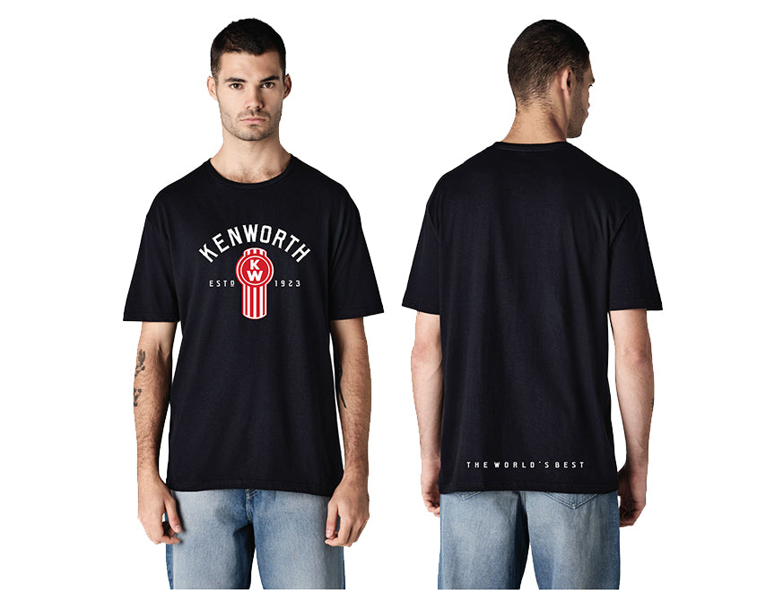 Front and back view of a man wearing the TEE SHIRT KW W900 SINCE 23 in black, featuring Kenworth's classic logo and "Est. 1923" on the front, plus "THE WORLD'S BEST" in small white text near the bottom on the back.