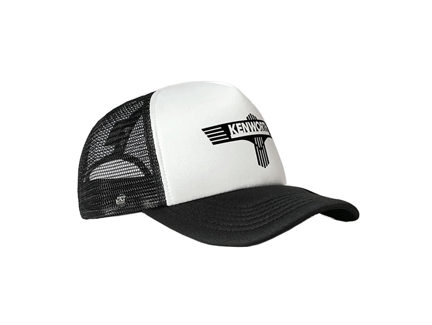 The CAP KW TRUCKER T BAR BLK/WHITE is a black and white trucker cap with a curved brim, mesh back, and bold black Kenworth logo with stylized wings on the front panel.