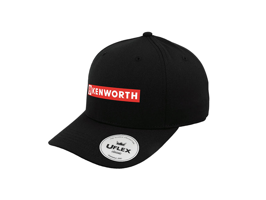 The CAP KW BANNER BLACK is a black cap with a curved brim, featuring a red and white KENWORTH logo on the front, adjustable fit, and UFlex Classic panel sticker on the brim.
