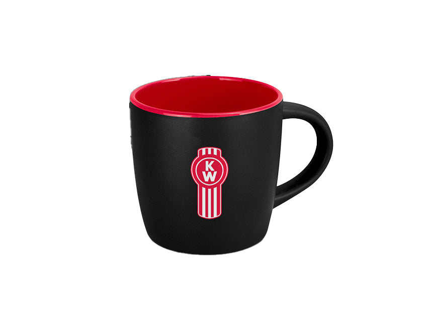 Enjoy your coffee in the MUG KW COFFEE, a black ceramic mug with a vibrant red interior and handle. It features a striking red and white circular KW logo on the front, all set against a white background for a stylish look.