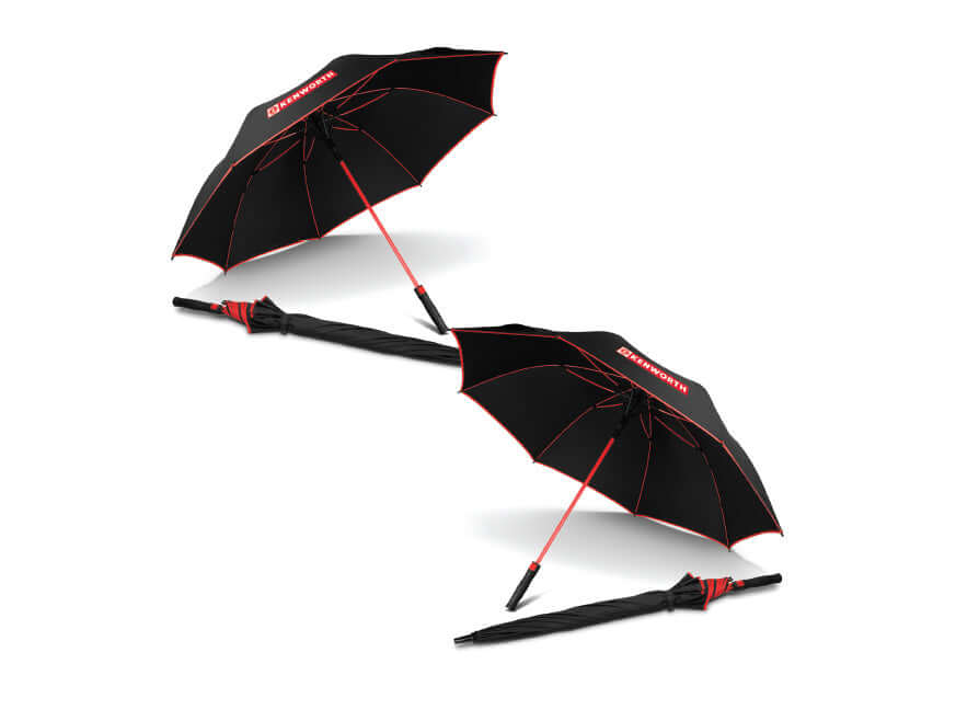 Two UMBRELLA KW MONSOON BLK/RED, one open and one closed, are shown on a white background. Both feature black wind-resistant handles with red accents and BRABUS branding.