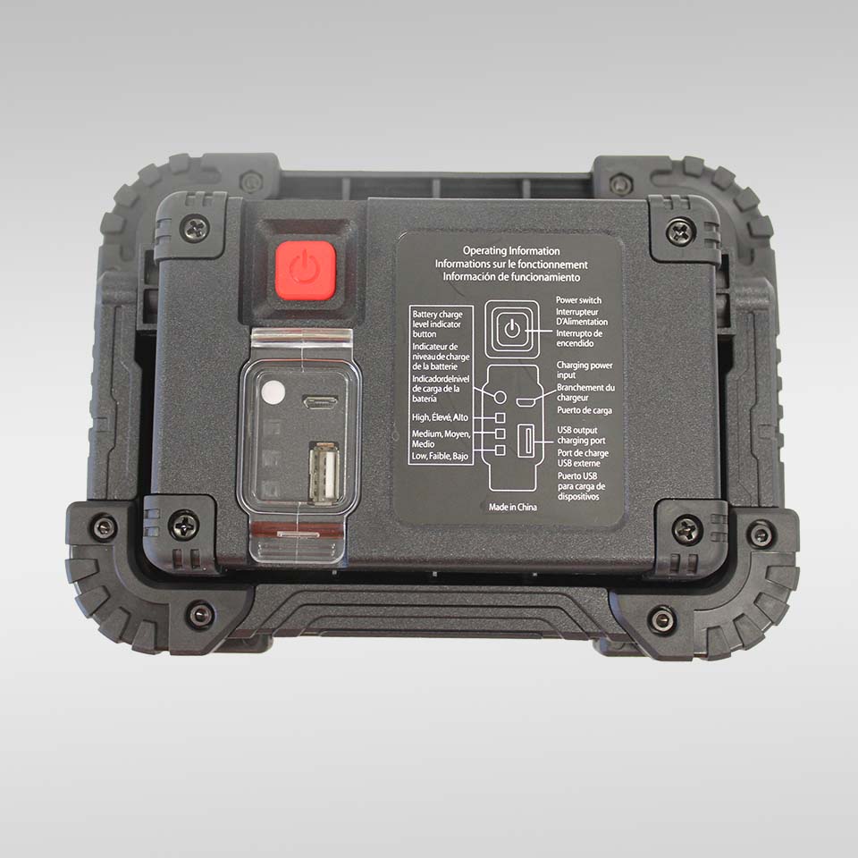 The TORCH LED TRP FREESTANDING is a rugged black device featuring a red power button, USB port, and printed instructions on top—ideal as a hands-free LED worklamp for roadside repairs—shown against a light gray background.