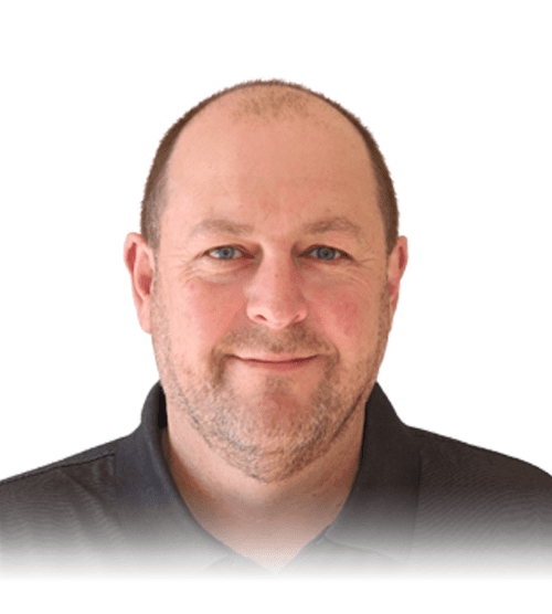 A middle-aged man with short hair and a trimmed beard, wearing a dark polo shirt, smiling and facing the camera against a white background.