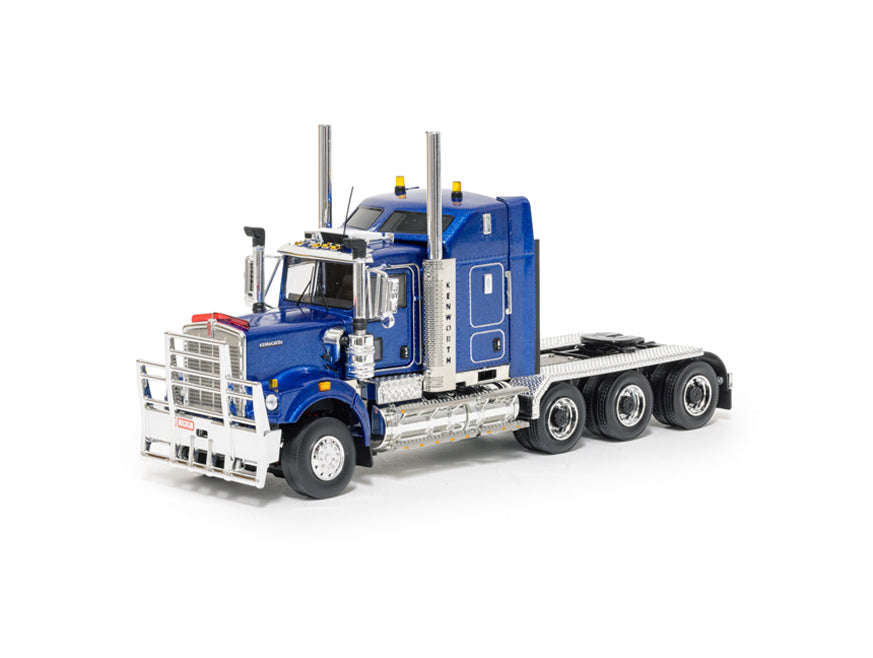 The MODEL C509 BLUE TRI-DRIVE is a blue scale semi-truck cab with chrome accents, tri-drive setup, six wheels, dual tall exhaust pipes, and a sturdy front grille guard. Displayed without a trailer against a white background.